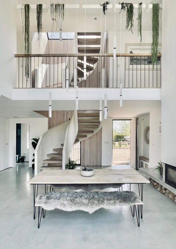 Design-led interior with hanging greenery and natural light — one of Elizabeth's filming locations